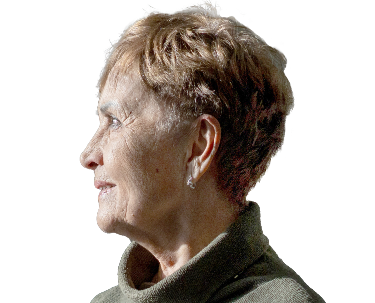 A woman wearing a turtleneck sweater looking into the distance